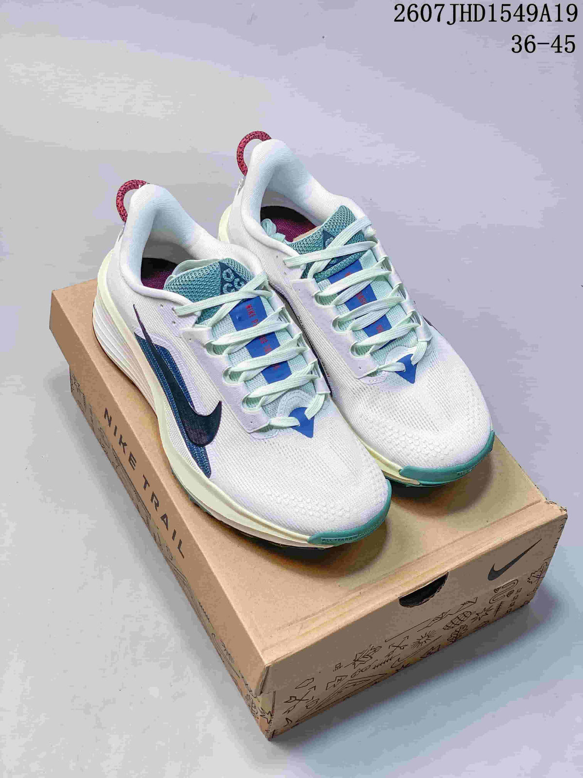Pair of white Nike Zoom Fly 5 sneakers with blue and teal accents displayed on a Nike shoebox.