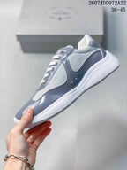 Side profile highlighting the gray glossy panels, white mesh sections, and textured white sole.