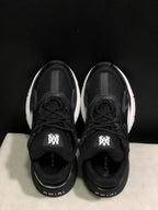 Top view showing the black mesh uppers, lace-up closure, padded tongues, and branded tongue labels.