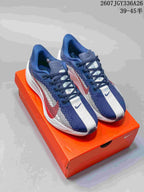 Pair of navy, white and red Nike Air Zoom Pegasus Plus sneakers displayed on an orange shoebox; image text shows style code 2607JGY336A26 and size range 39–45.