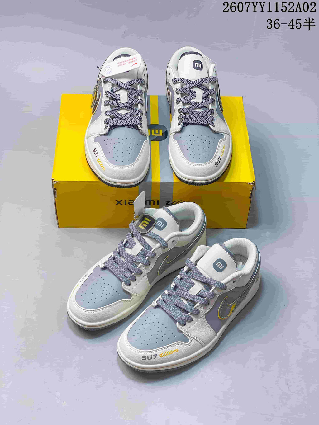 Several views of gray and white SU7 Ultra sneakers arranged on a yellow box