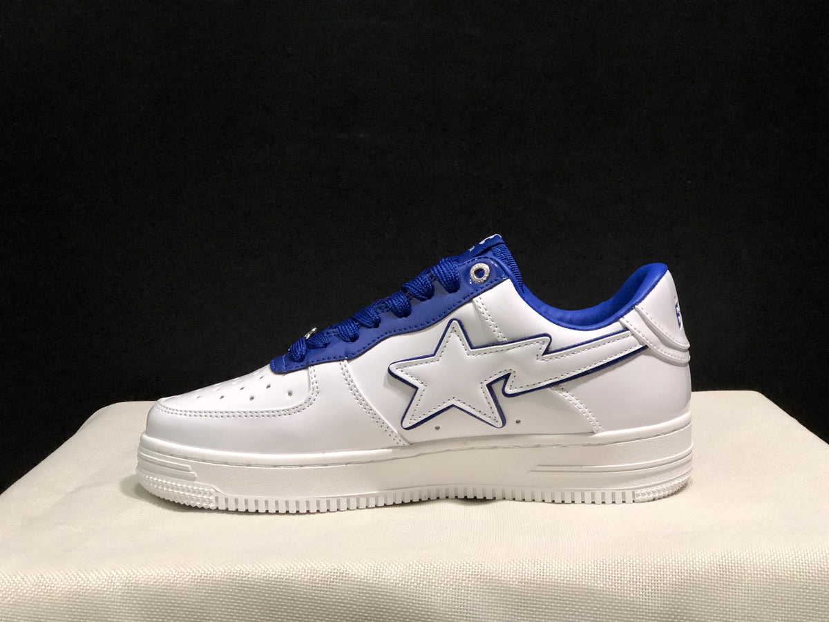 Side profile showing the white low-top silhouette, large outlined star detail, blue collar, and layered outsole.