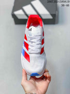 Top view of the sneaker showing the white lace-up front, perforated toe area, and red collar lining.