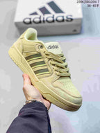 Cream-toned adidas Entrap sneaker with dark side stripes and a matching tonal outsole.