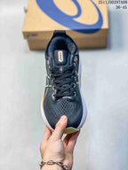 Top view of the black lace-up running shoe showing the padded tongue, perforated-looking forefoot area and green eyelet accents.