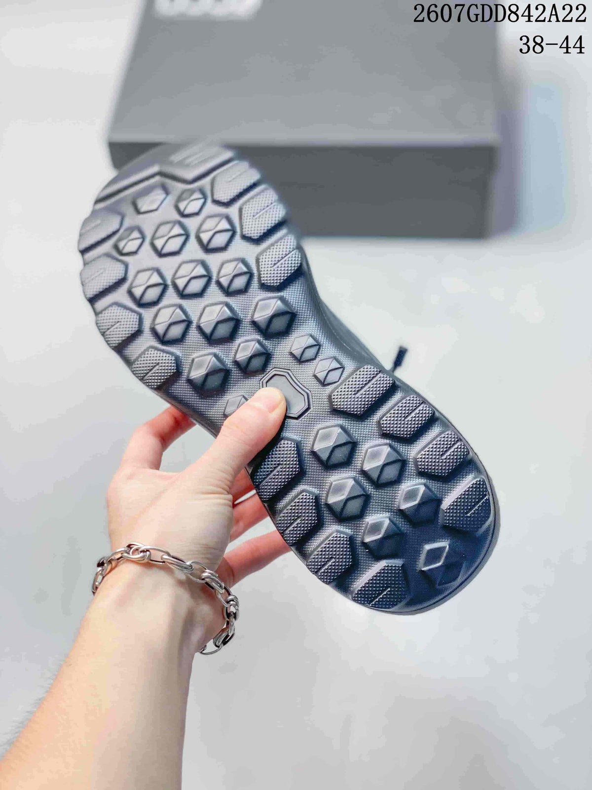 Close-up of the textured lugged outsole on a gray ECCO sneaker.