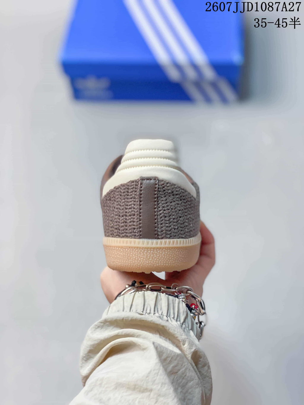 Rear view showing the brown textile heel, white heel accent, and gum-colored outsole.