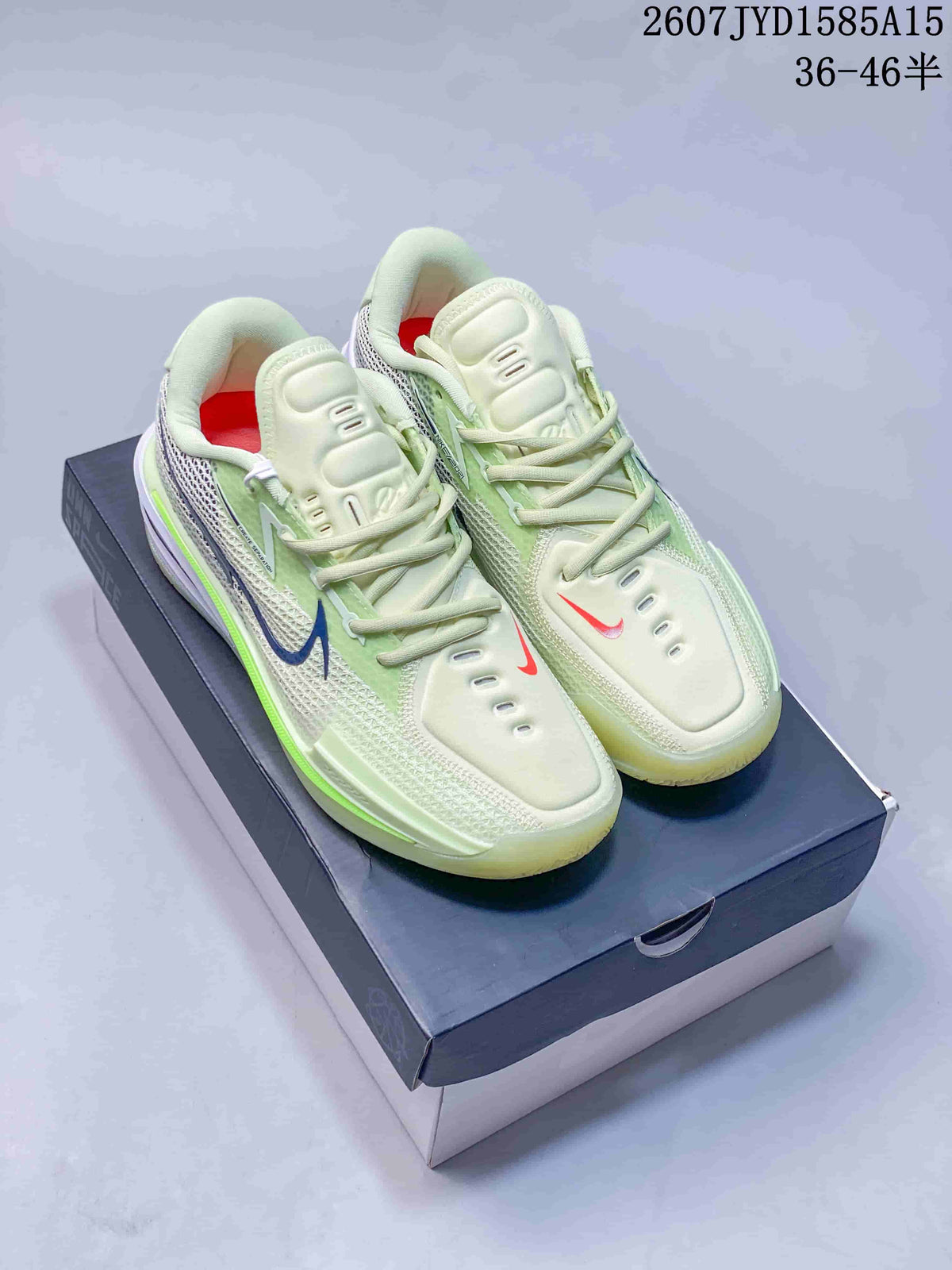 Pair of pale cream and light green Nike low-top basketball shoes displayed on a shoebox, with style code and size range text visible above.
