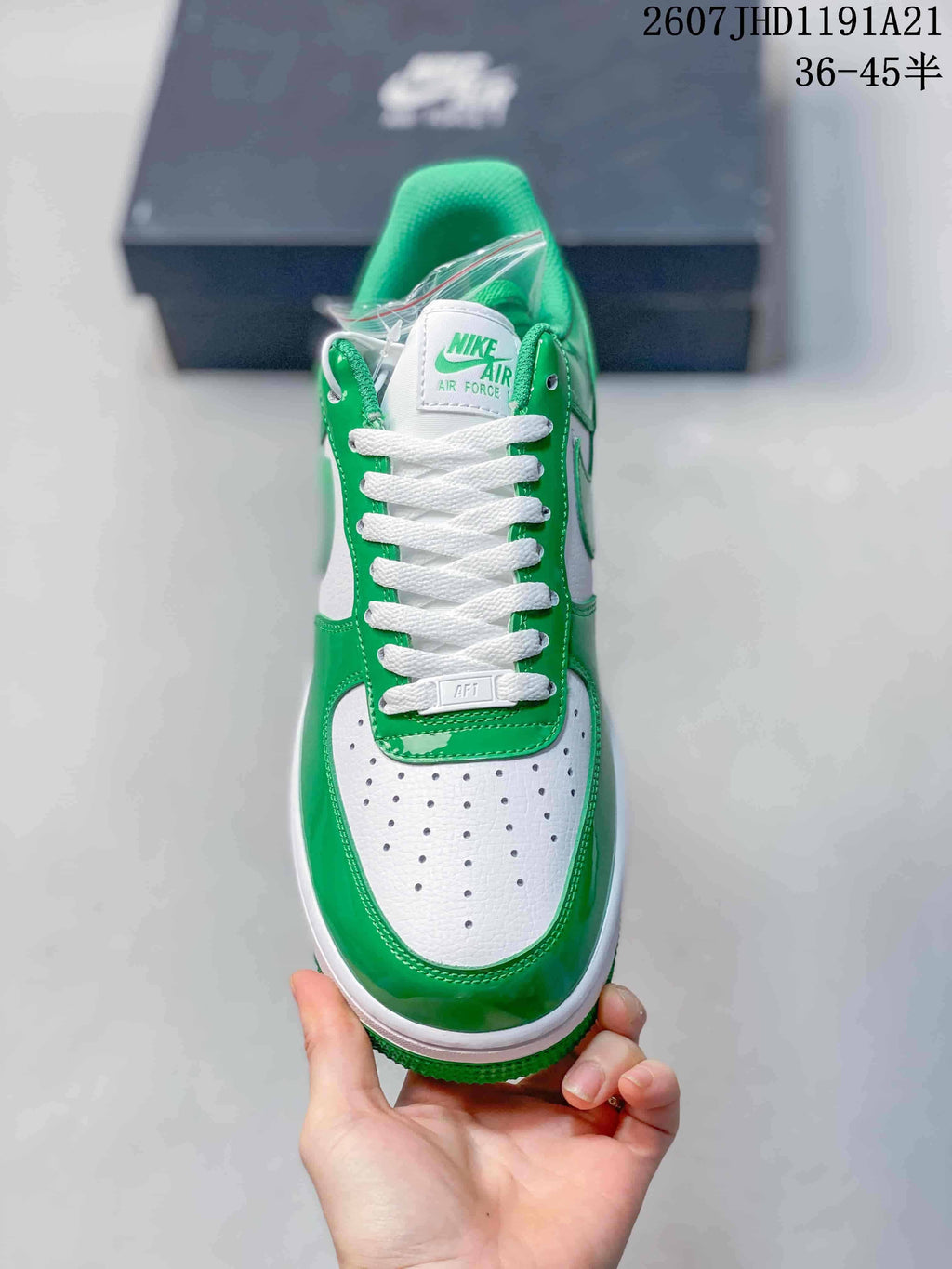 Top view highlighting the white perforated toe box, green overlays, white laces, and tongue branding.