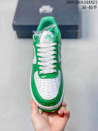 Top view highlighting the white perforated toe box, green overlays, white laces, and tongue branding.
