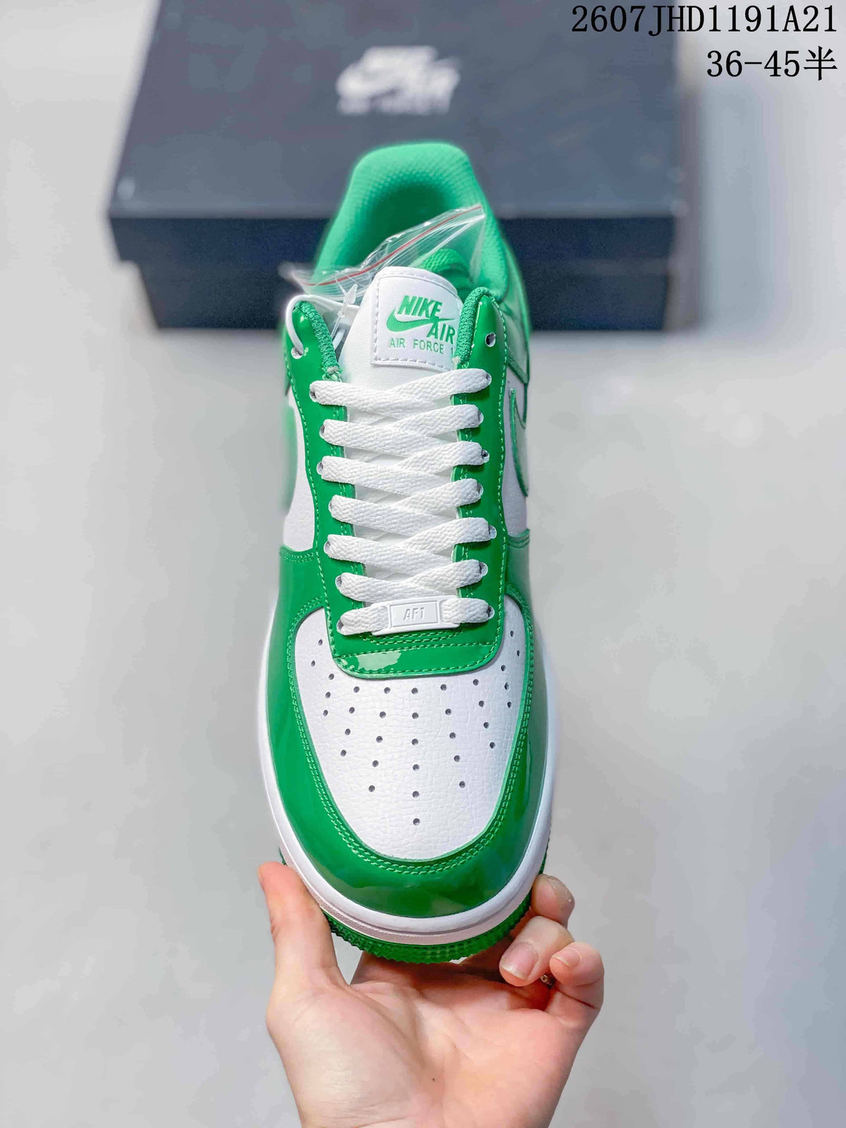 Top view highlighting the white perforated toe box, green overlays, white laces, and tongue branding.