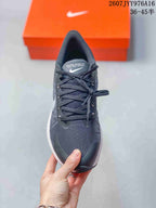 Top view showing the dark textured upper, laces, and toe area of the sneaker.