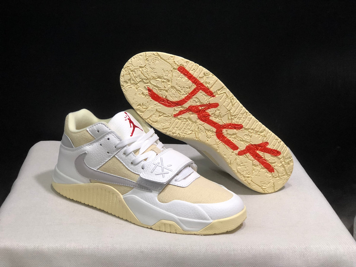 Sneaker outsole view showing the textured cream rubber sole and red graphic detailing.