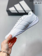 Side profile showing the stitched panels, adidas stripe detailing and low-profile sole.