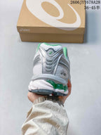 Rear view of the shoe showing layered heel panels and green sole accents.
