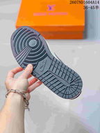Close view of the sneaker outsole showing circular pivot-style grooves and a textured dark rubber tread.