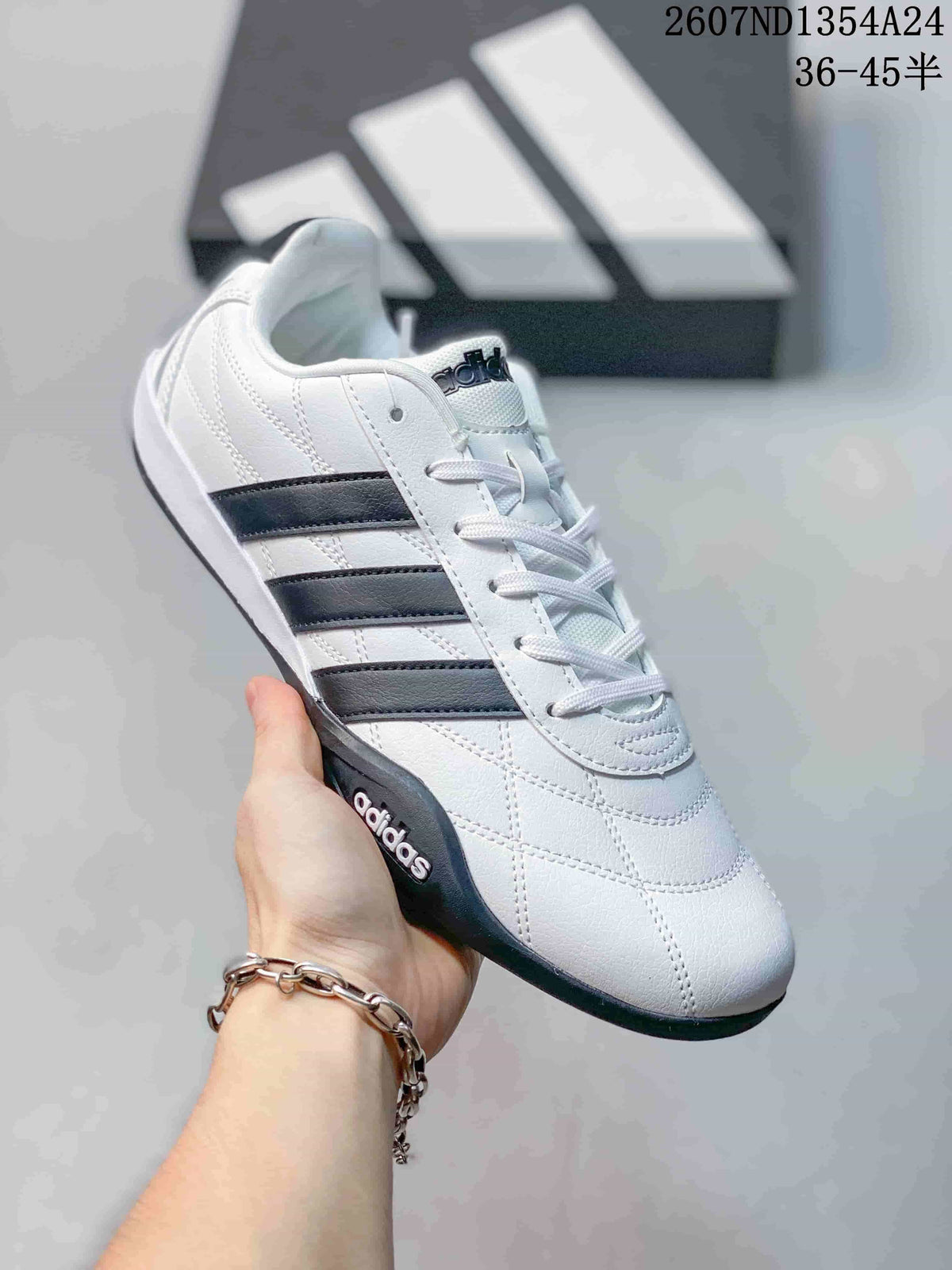 White adidas Adipista low-top sneaker with black side stripes and a dark outsole, shown at an angle.