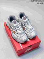 White Nike Shox Ride 2 sneakers with orange and dark accents displayed on a red shoe box.