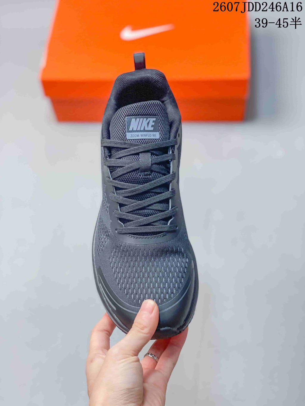 Front view of the shoe showing the mesh-style toe box, laces, and tongue label reading Nike Zoom Winflo 9X.
