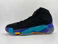 Side view of a black high-top basketball sneaker with blue, teal, orange, and gray accents