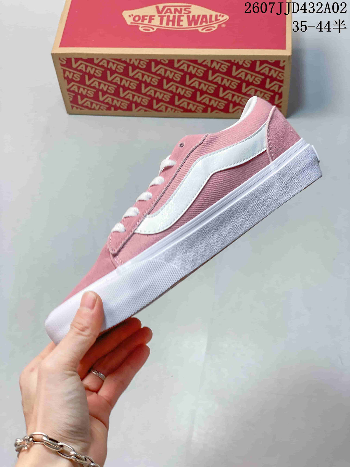 Side profile of a pink low-top sneaker with a white stripe