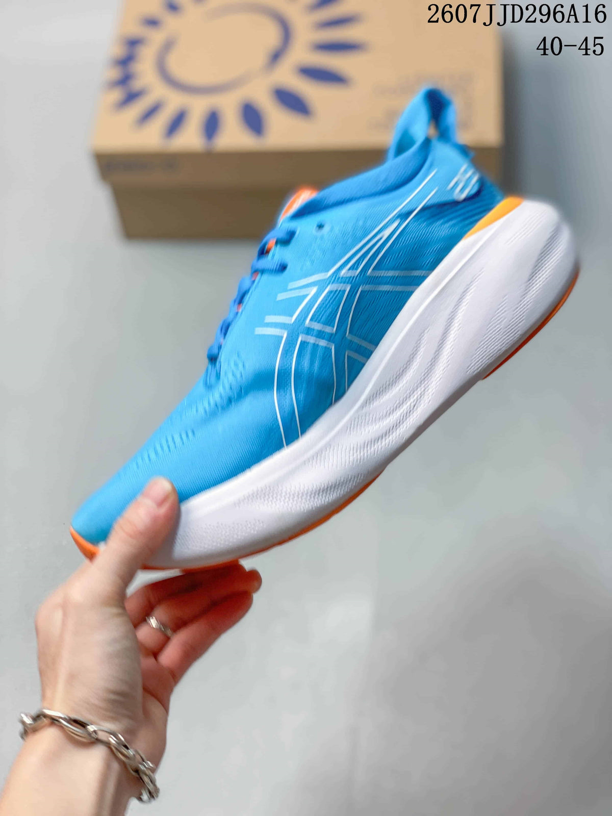 Side view of the blue low-top running shoe showing the outlined ASICS logo, white sculpted midsole, and orange trim.