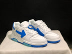 Three-quarter front view of the paired white and blue low-top sneakers with blue tag accessory.