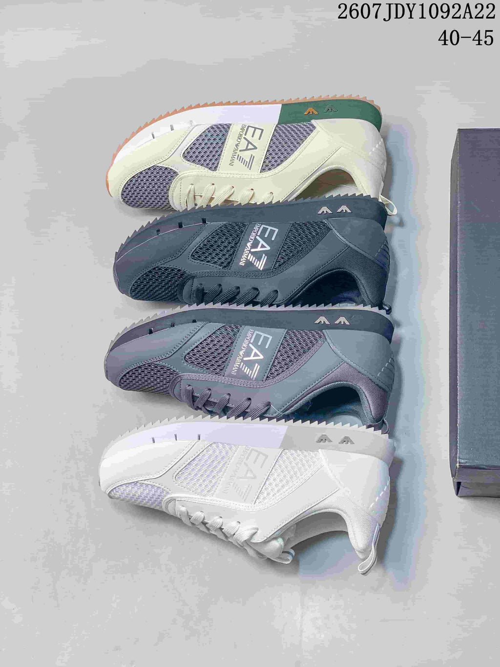 Four EA7 sneaker colorways arranged together, including cream, black, gray and white designs.