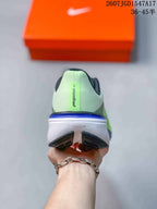 Rear view of the sneaker showing the Pegasus 42 heel marking, pale green upper, and layered outsole.