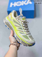 Light gray and white HOKA Mafate Speed 2 sneaker with neon yellow-green trim and blue outsole accents.