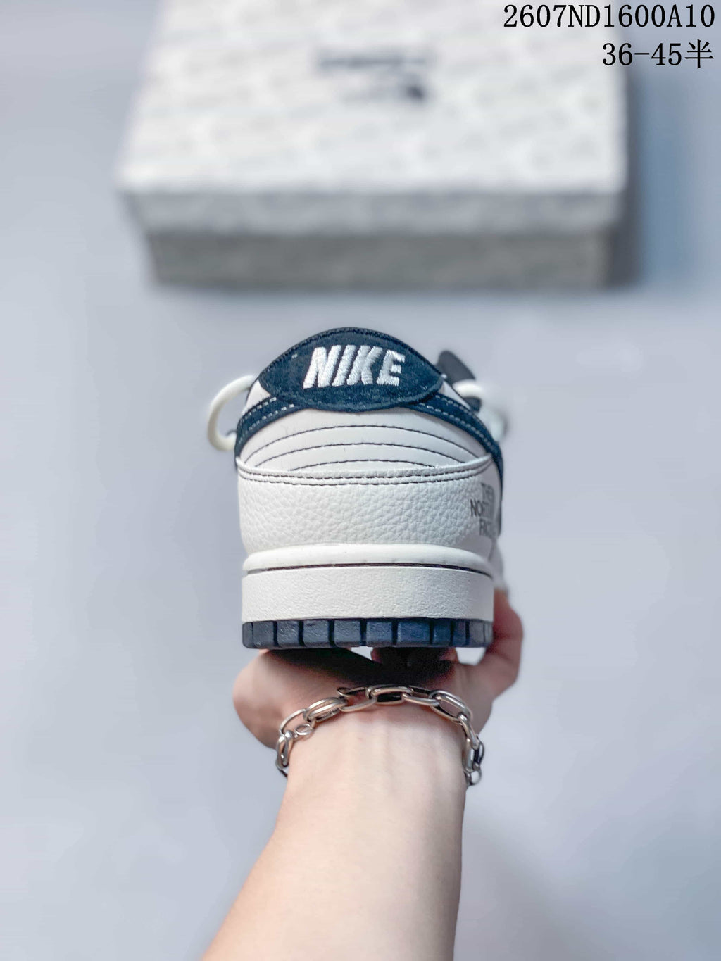 Rear view showing the white heel, navy heel tab, Nike branding and dark outsole edge.