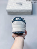 Rear view showing the white heel, navy heel tab, Nike branding and dark outsole edge.