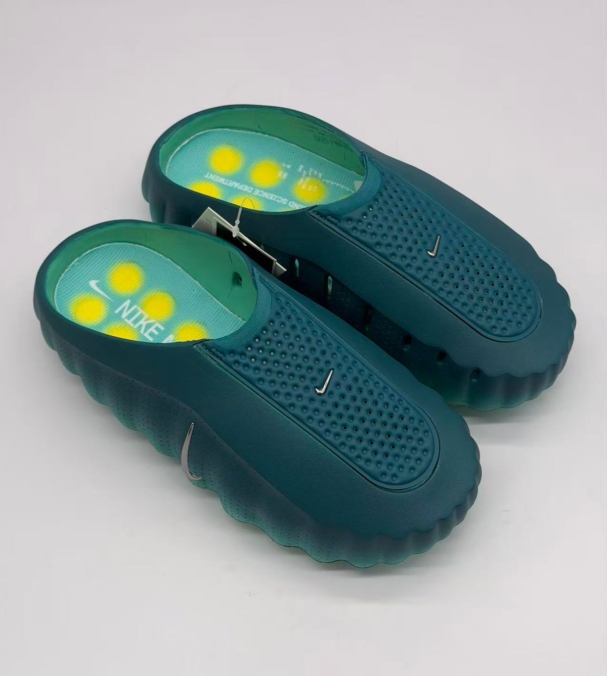 Top angled view showing the green pair, textured footbeds, and yellow circular accents.
