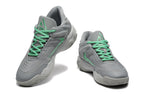Pair of gray Nike basketball sneakers with mint-green laces, shown from front and side angles