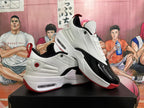 Angled view of the pair highlighting the white upper, black toe panels, red accents, and Jordan heel branding.