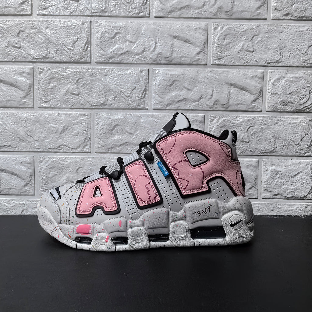 Opposite side view of pink and grey Nike sneakers with oversized AIR lettering