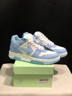 Pair of light blue and white OFF-WHITE Out Of Office low-top sneakers displayed on a green shoe box.