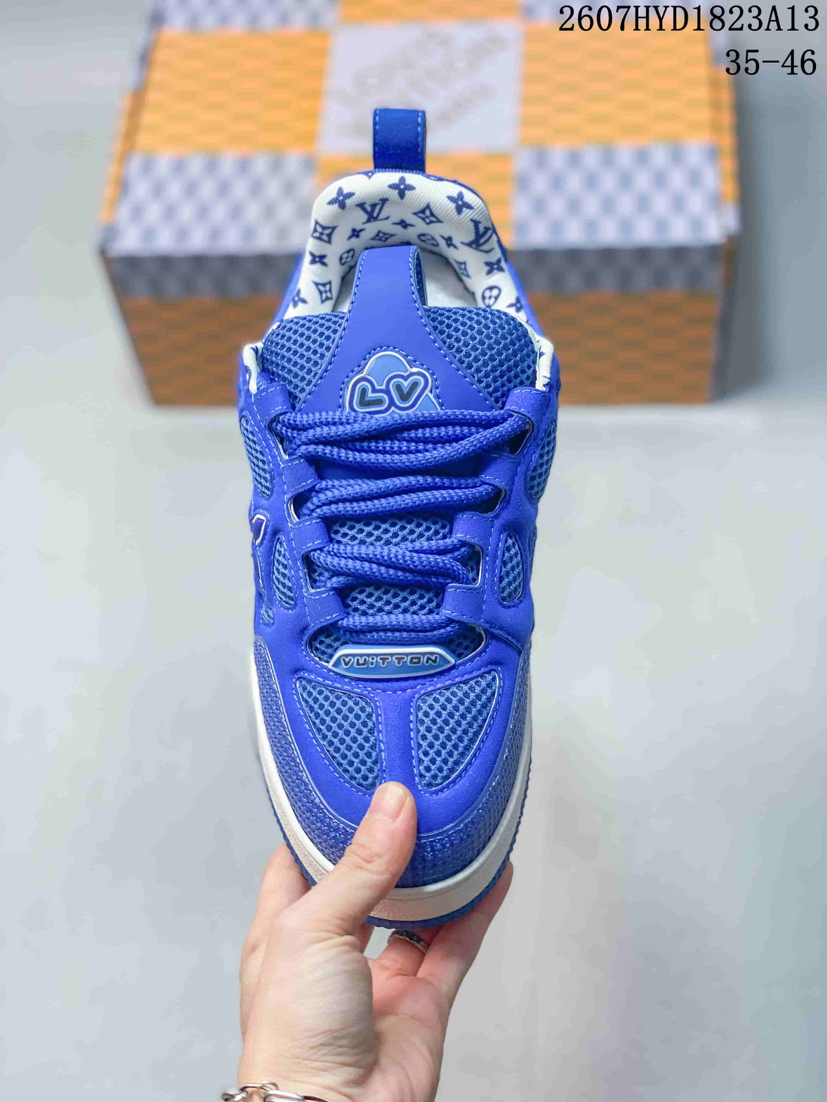 Top view of a blue lace-up sneaker showing the mesh tongue, patterned collar lining, and branded upper details.