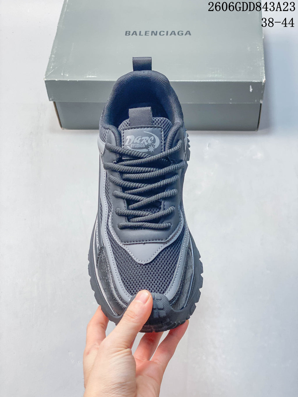 Top view of the grey lace-up sneaker showing its mesh panels and tongue label.