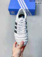 Top view showing the white laces, adidas tongue branding, and stitched toe detailing.