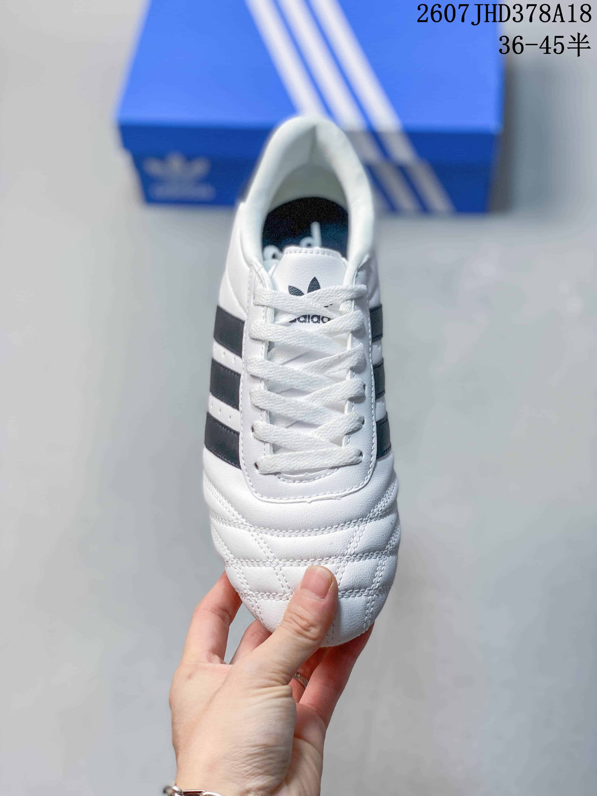 Top view showing the white laces, adidas tongue branding, and stitched toe detailing.