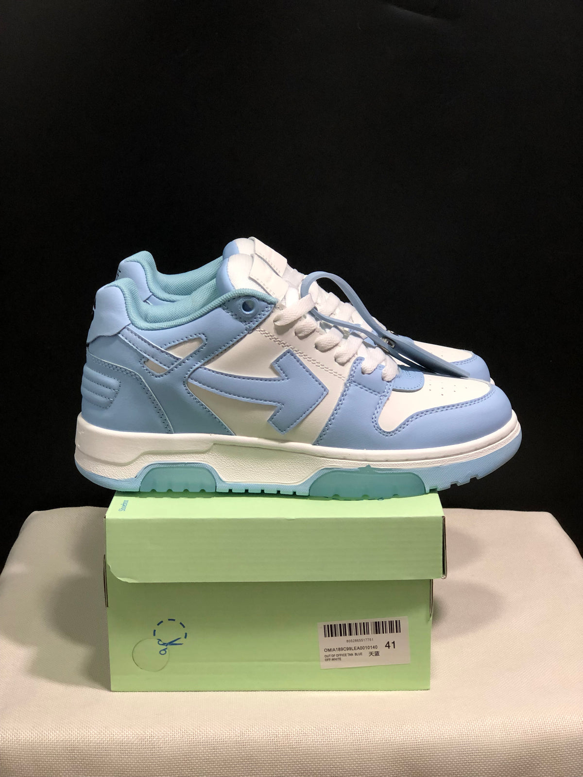 Side view showing the layered blue-and-white upper, padded collar, and textured outsole.