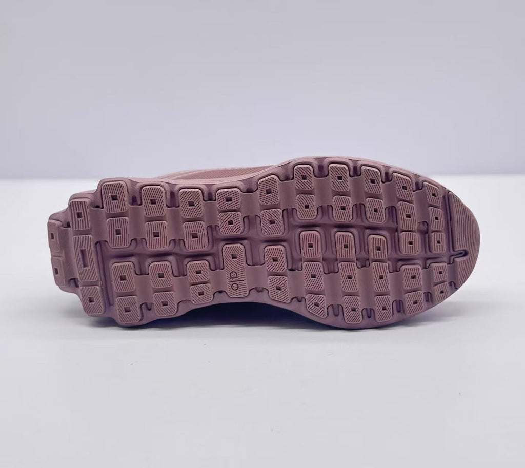 Underside view showing the pink outsole with segmented tread blocks.