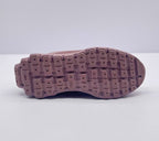 Underside view showing the pink outsole with segmented tread blocks.