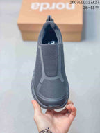 Front view of the dark charcoal slip-on hiking sneaker showing the elasticated upper panel, reinforced toe area, and tonal construction; overlay text shows style code 2607GDD327A27 and sizes 36–45.