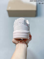 Rear view of the white and pale pink sneaker showing the padded heel, layered sole, and heel branding detail.