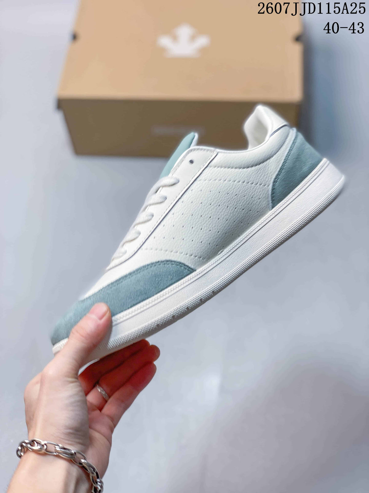 Side profile showing the white perforated upper, light blue heel and toe panels, lace-up front, and low-top silhouette.