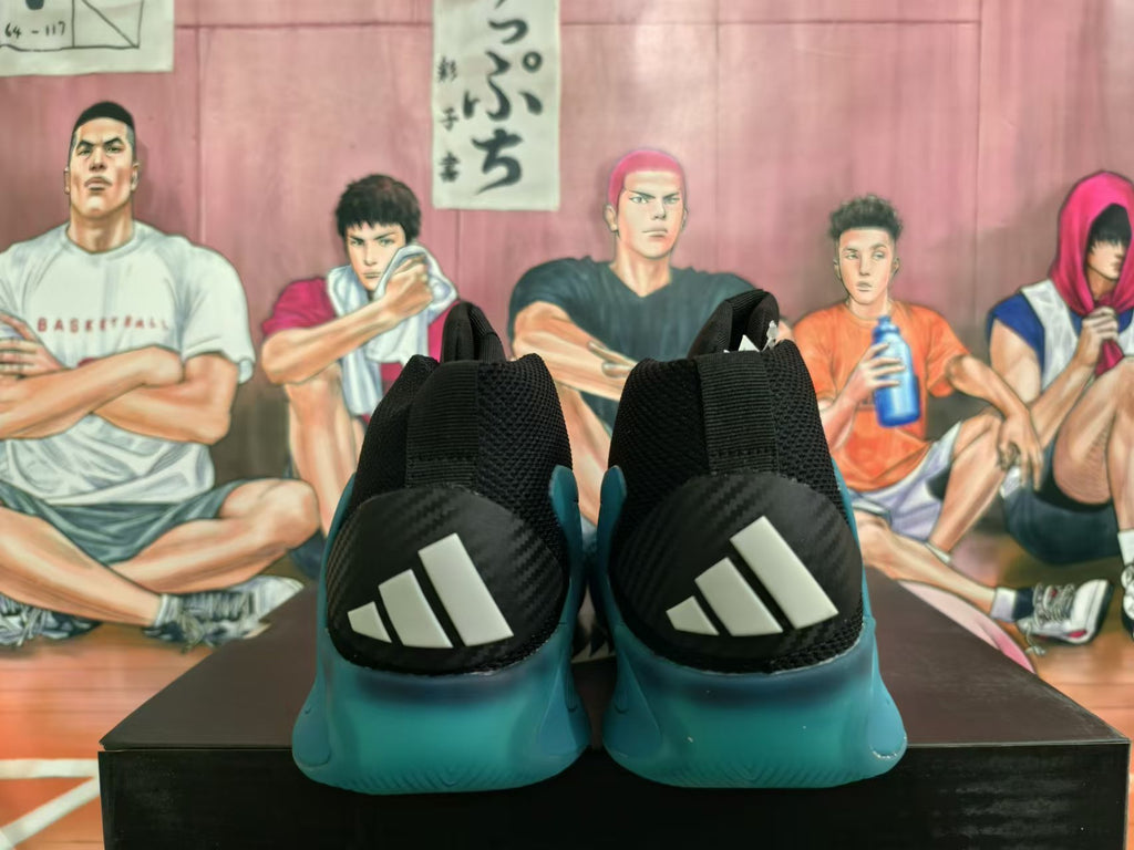 Rear view of the shoes showing black heel panels with three white Adidas stripes and teal soles.