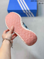 Close-up of the pink outsole showing a repeating Adidas-style surface pattern.