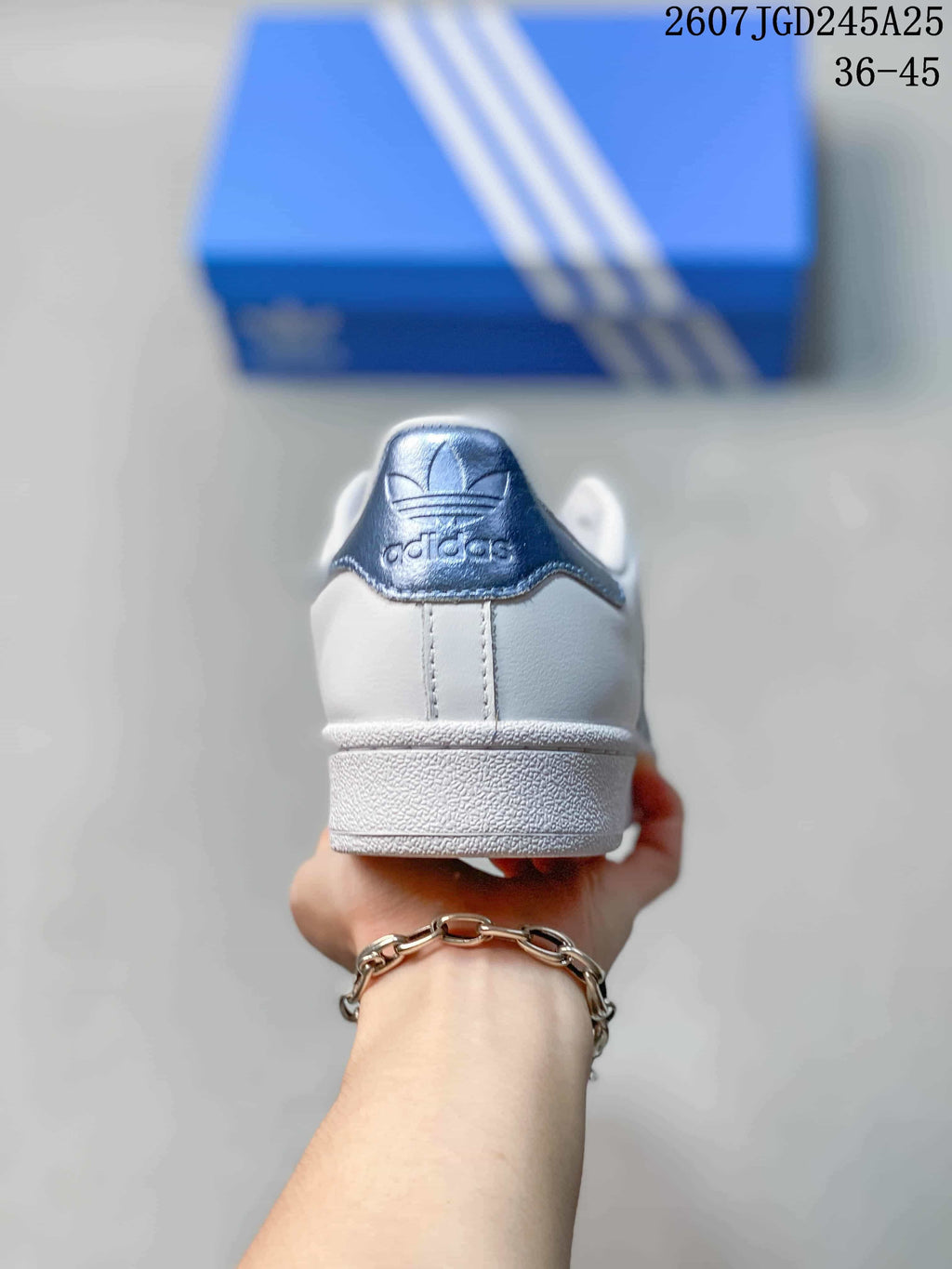 Rear view showing the white heel, blue heel tab, and adidas branding.